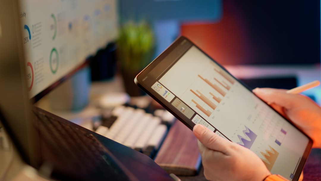 Data analytics dashboard displayed on a tablet in a modern workspace