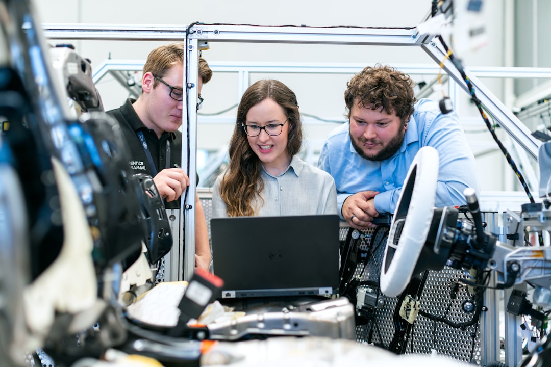 Engineers collaborating on technical systems representing cross-functional governance and AI transparency register management