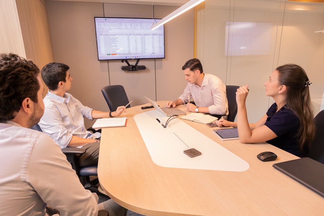 Business professionals collaborating around a conference table discussing enterprise governance and risk management strategy