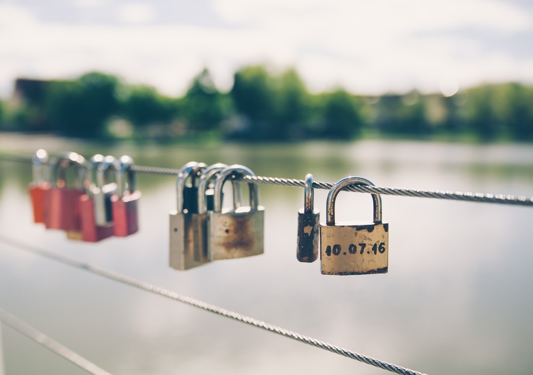 A padlock on a metal fence symbolizing security and intellectual property protection