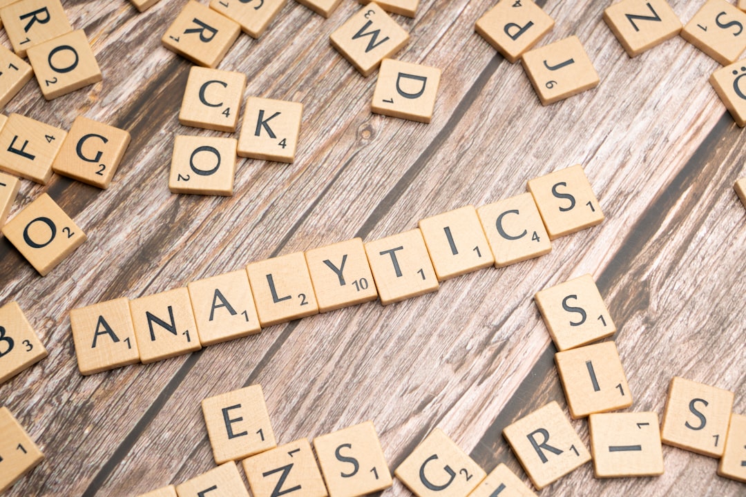 Statistics spelled out in letter tiles on a wooden surface representing data analysis